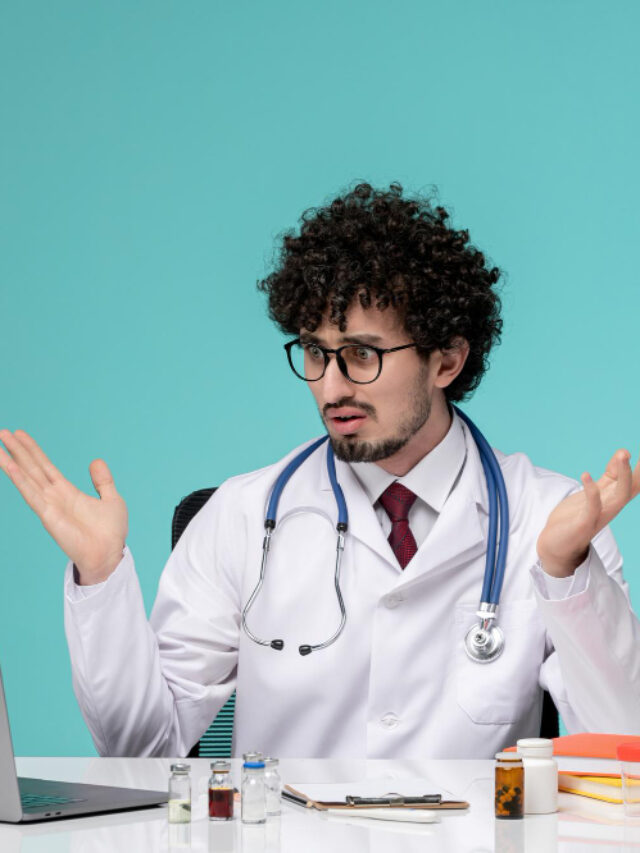 cropped-medical-young-serious-handsome-doctor-working-computer-lab-coat-confused-waving-hands.jpg